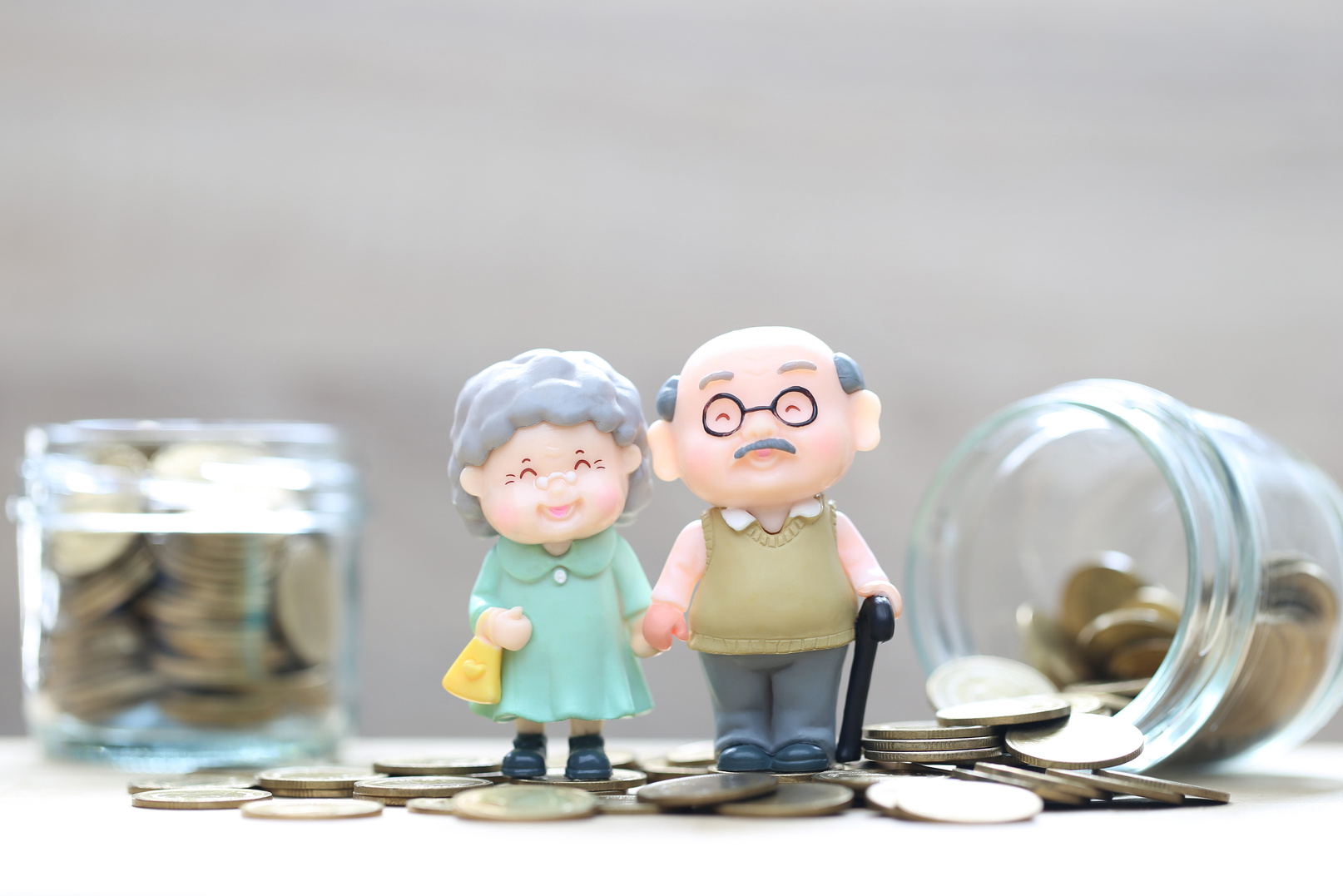 Mutual fund,Love couple senior and gold coin money in the glass